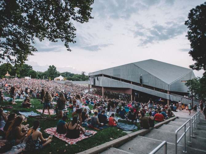 Photo of patrons on the lawn in front of the main stage pavillion