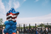 Image of red white and blue balloons at the mann gates